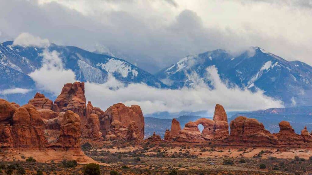 Red rock formations and snowy mountains in Utah, symbolizing the balance between strength and healing through EMDR therapy.