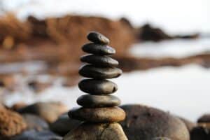 Stacked smooth stones representing body-mind balance and grounding in somatic trauma therapy.